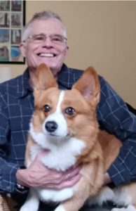 John Coville, retired acupuncturist, with Beni the office dog.