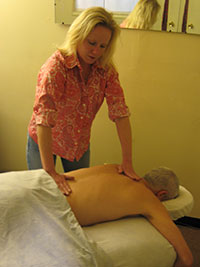 A therapist working on a client during a therapeutic massage session.