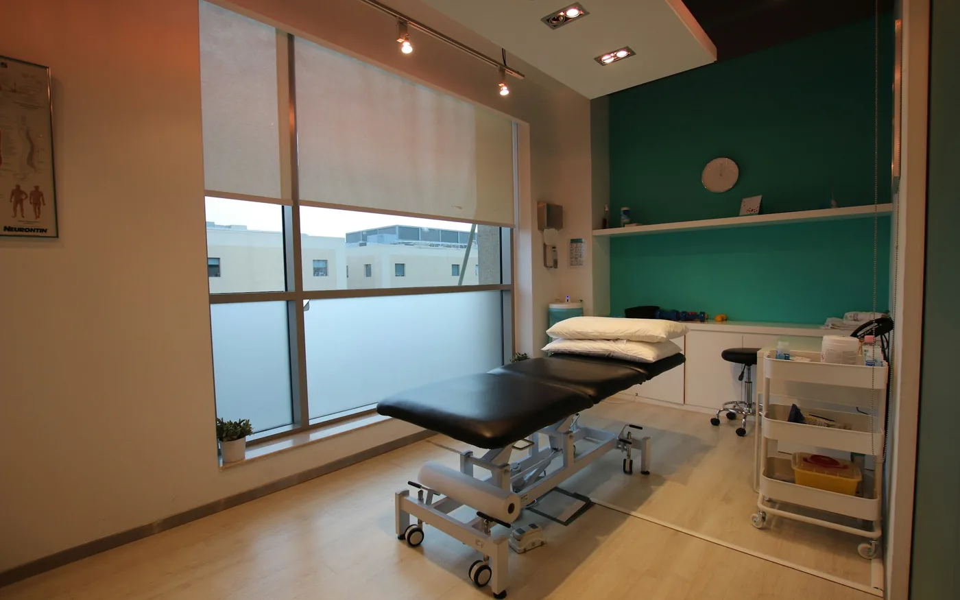 A quiet treatment room with a made-up table, ready for a session