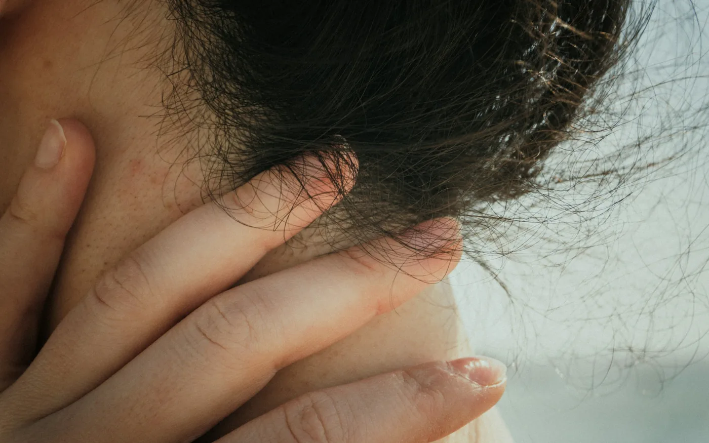A headache that starts at the base of the skull and spreads forward
