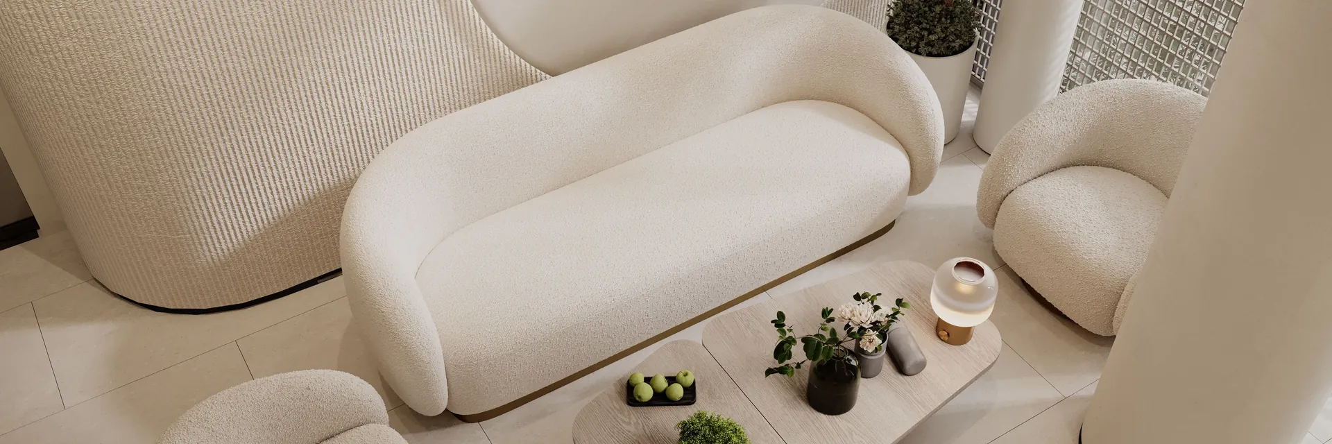 A calm, softly lit waiting area with a cream sofa and potted plants.