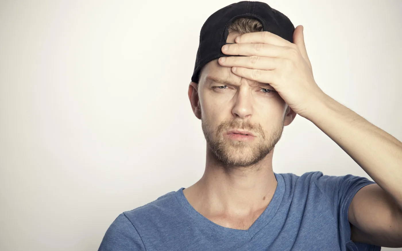 A person shielding their eyes from light during a migraine attack