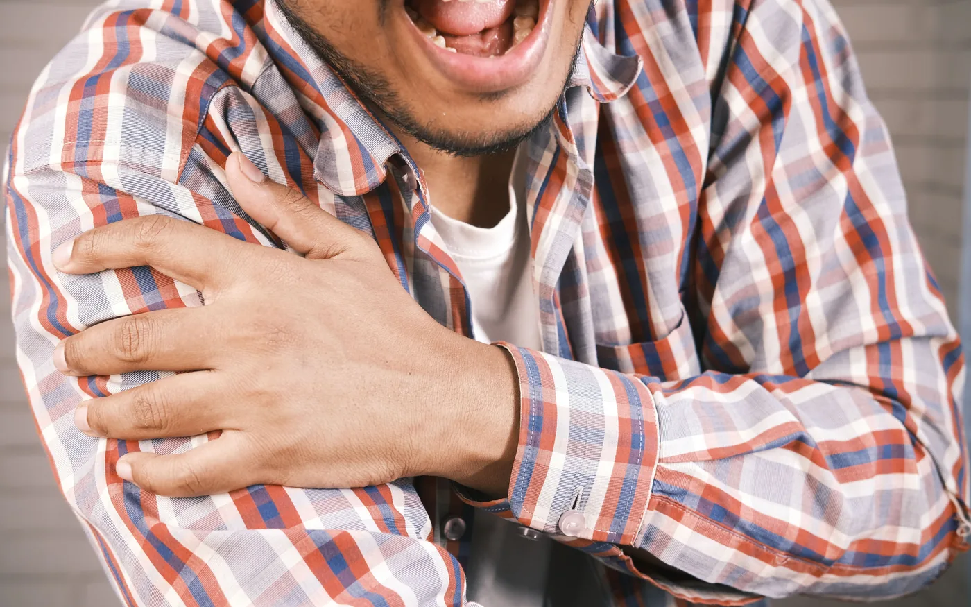 Rotator cuff pain is felt on reaching overhead, unlike the stiffness of frozen shoulder