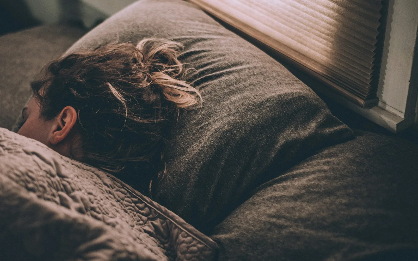 Side-lying sleep with a pillow between the knees, which takes load off the lumbar spine