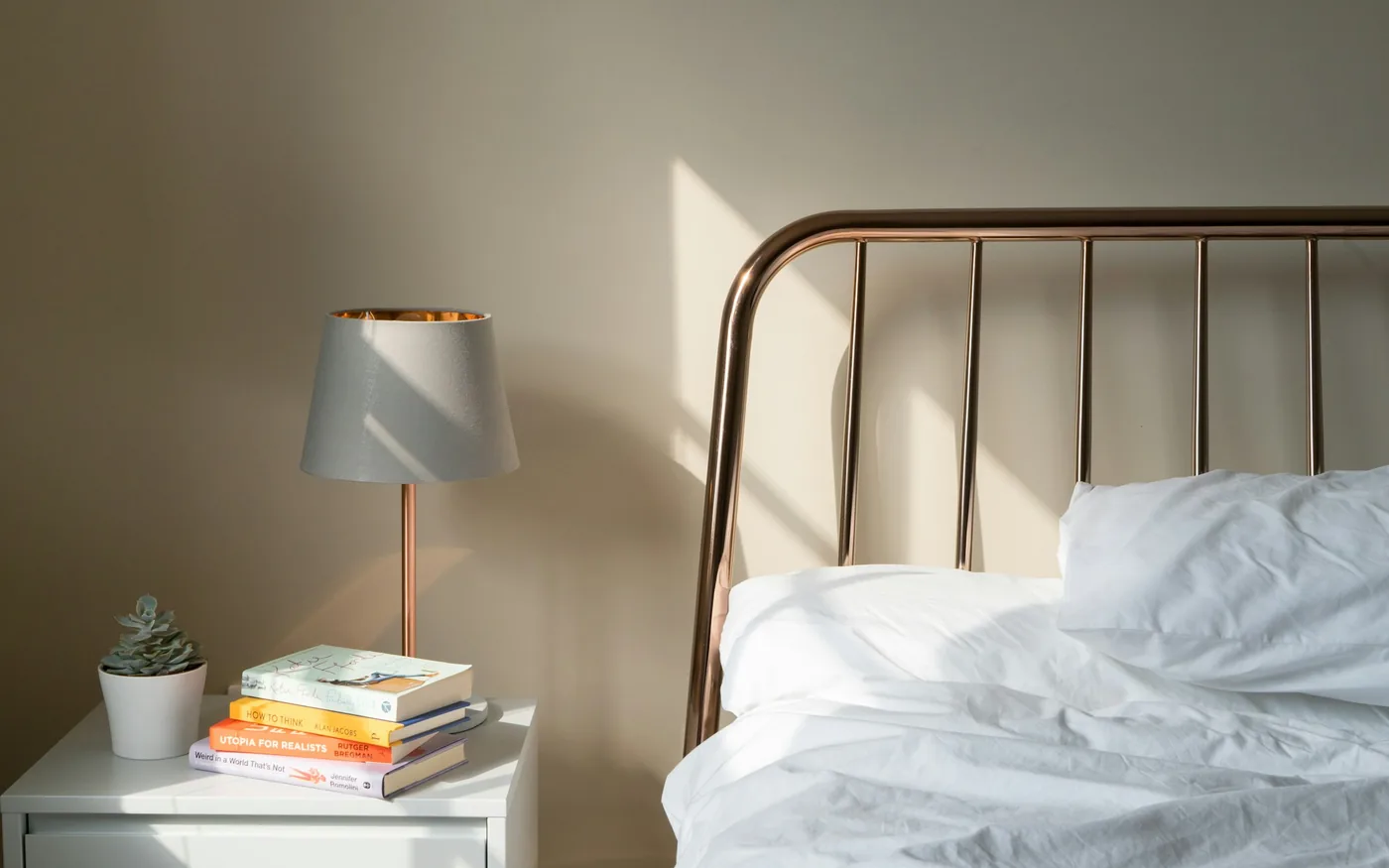 A softly lit bedroom, where improved sleep is often the first change people notice